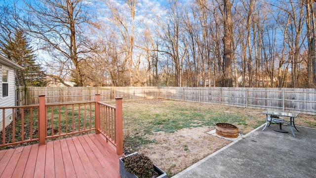 view of yard with a patio, a deck, and an outdoor fire pit