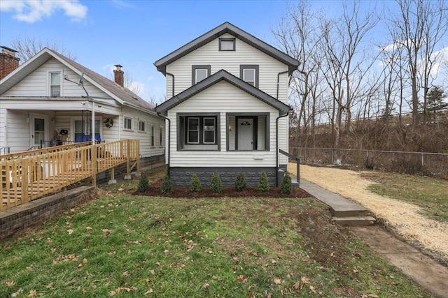 view of front of house featuring a porch and a front lawn