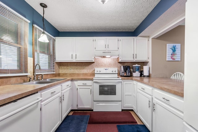 kitchen featuring white cabinetry, sink, kitchen peninsula, pendant lighting, and white appliances