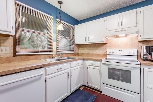 kitchen with a textured ceiling, white appliances, sink, white cabinetry, and hanging light fixtures