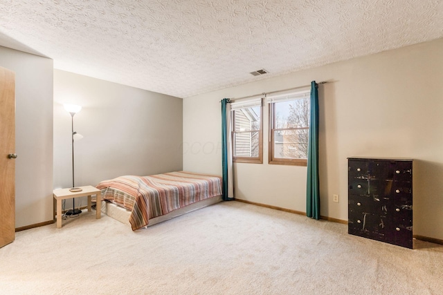 carpeted bedroom featuring a textured ceiling