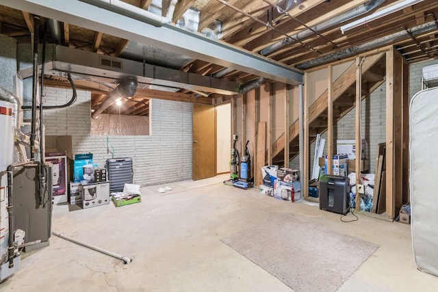 basement featuring brick wall