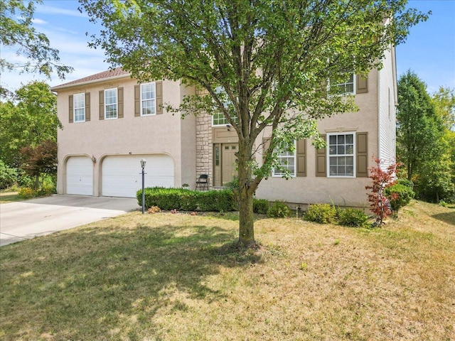 view of front of home with a front yard and a garage