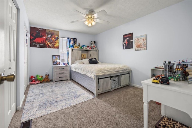 bedroom with ceiling fan, a closet, carpet floors, and a textured ceiling