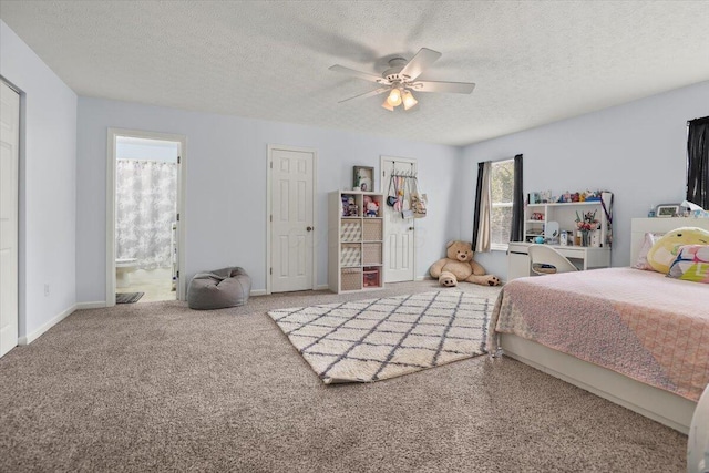 carpeted bedroom with a textured ceiling, ensuite bath, and ceiling fan