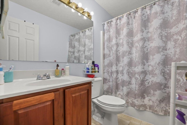 bathroom featuring vanity, toilet, and a textured ceiling