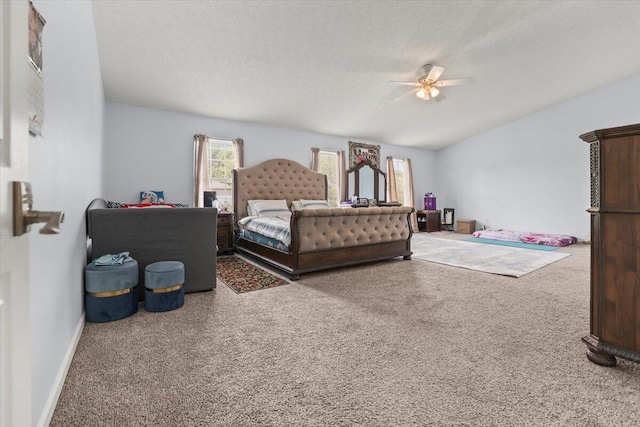 carpeted bedroom with ceiling fan and a textured ceiling