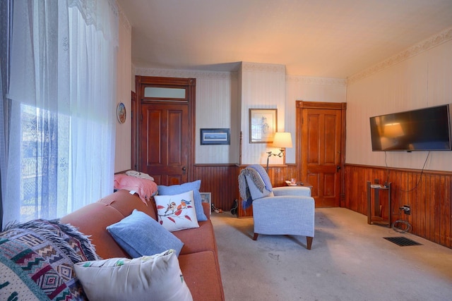 living room featuring carpet flooring and wood walls