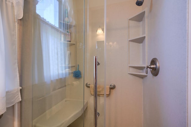 bathroom featuring a shower with shower door