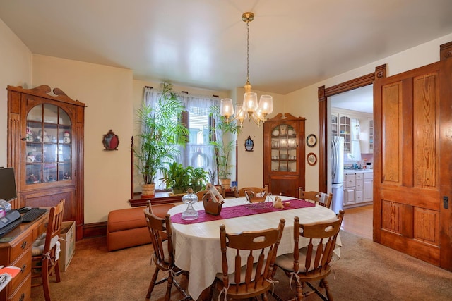 carpeted dining area with a notable chandelier