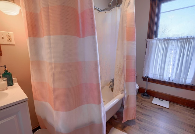 bathroom with vanity, shower / bathtub combination with curtain, and hardwood / wood-style floors