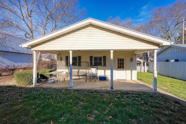 back of house featuring a patio and a lawn