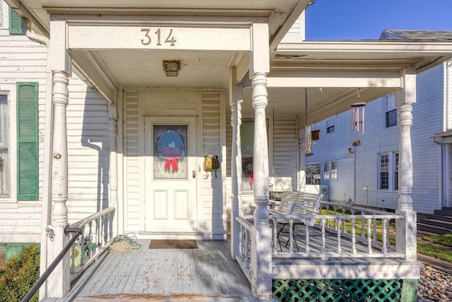 view of exterior entry with covered porch