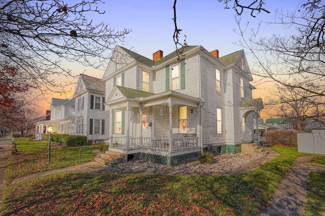 exterior space with a porch and a lawn