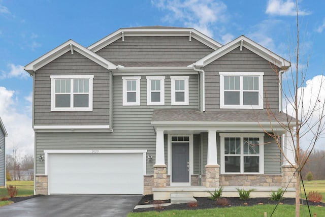 craftsman inspired home featuring covered porch and a garage