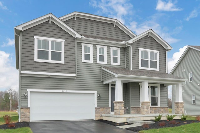 craftsman-style house with a porch and a garage