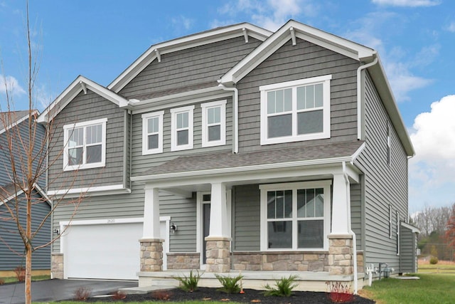 craftsman-style house featuring a porch and a garage