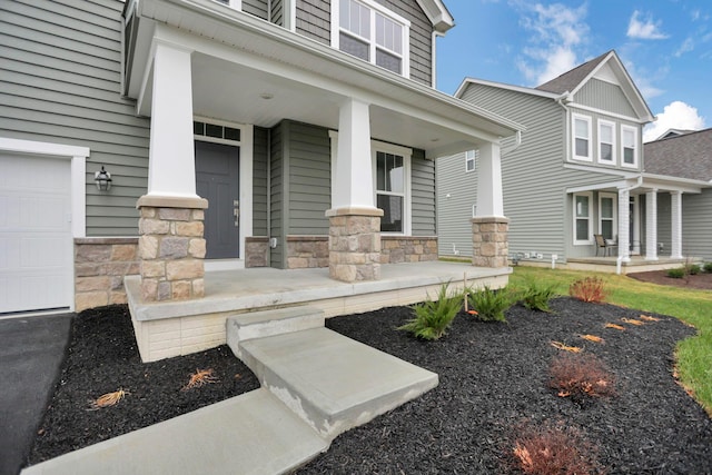 doorway to property featuring a garage and covered porch