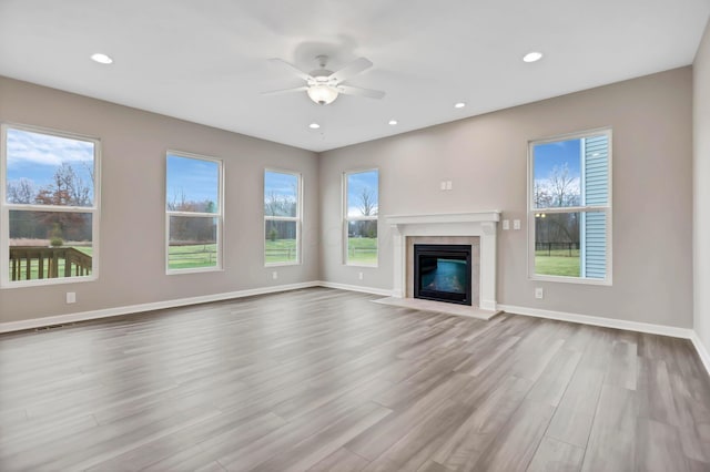 unfurnished living room featuring light hardwood / wood-style floors and ceiling fan