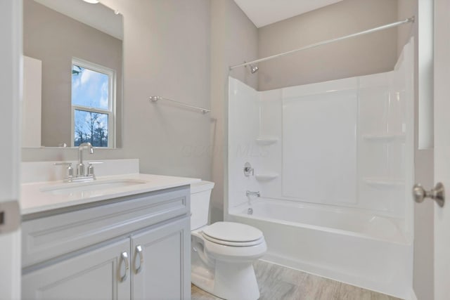 full bathroom featuring toilet, vanity, and tub / shower combination