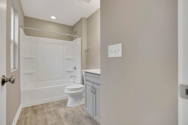 full bathroom featuring wood-type flooring, vanity, shower / bath combination, and toilet