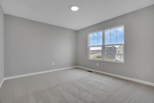 carpeted empty room with plenty of natural light