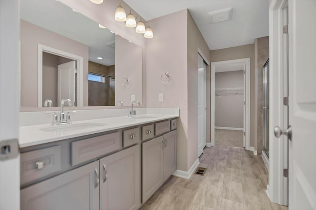 bathroom with vanity and a shower with shower door