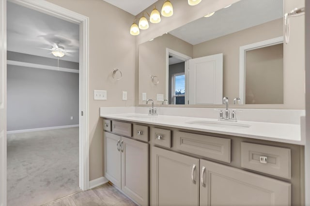 bathroom with ceiling fan and vanity