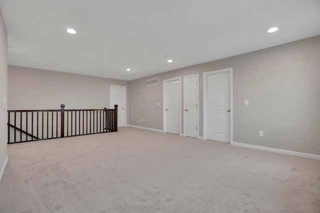 empty room featuring light colored carpet