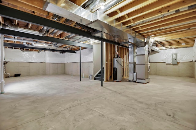 basement with heating unit, electric panel, and water heater