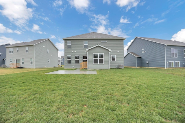 rear view of house with a yard and a patio