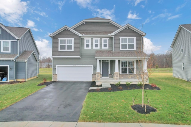 craftsman house featuring covered porch, a garage, and a front lawn