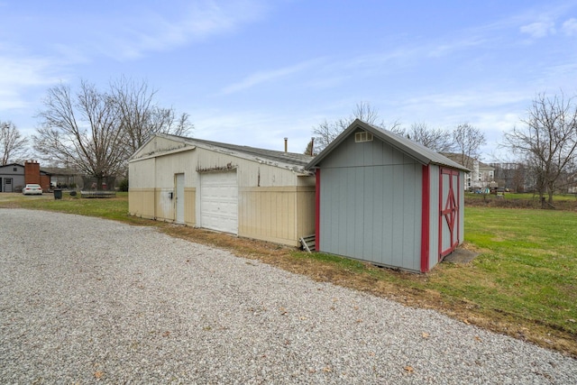 view of outdoor structure with a garage and a yard