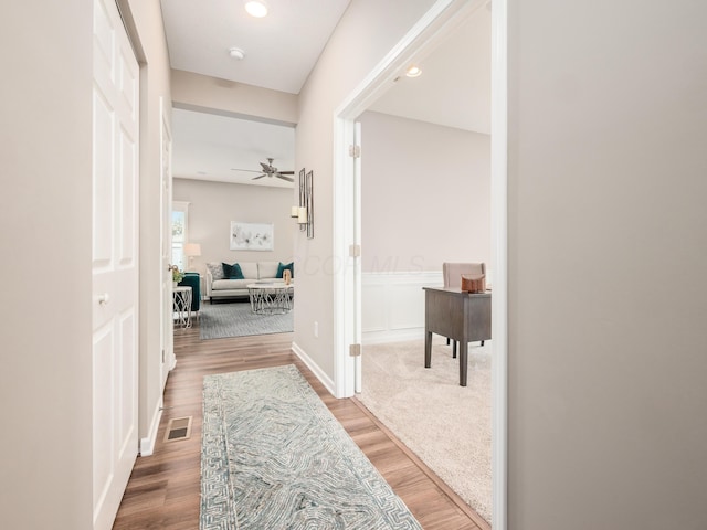 hall with hardwood / wood-style flooring