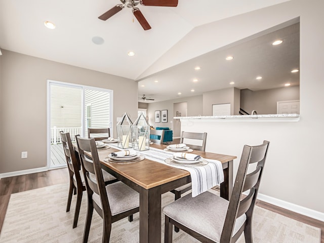 dining space with lofted ceiling, ceiling fan, and light wood-type flooring