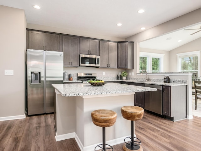 kitchen featuring a kitchen breakfast bar, a kitchen island, and stainless steel appliances