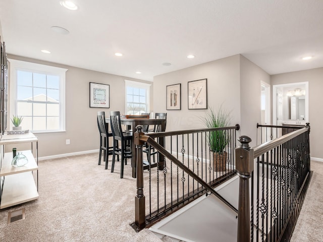 staircase featuring carpet