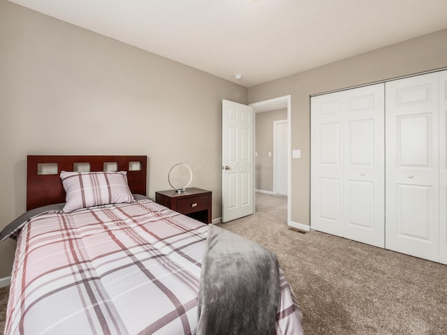 carpeted bedroom with a closet