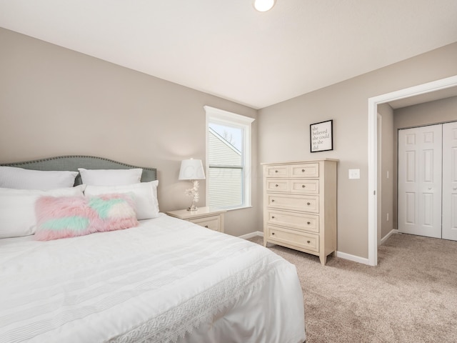 bedroom with light carpet and a closet