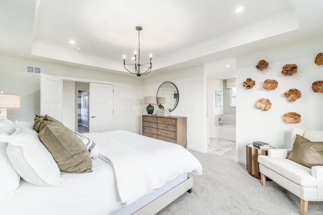 bedroom with light colored carpet, a raised ceiling, crown molding, an inviting chandelier, and connected bathroom