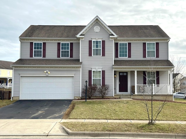 view of front facade featuring a front yard and a garage