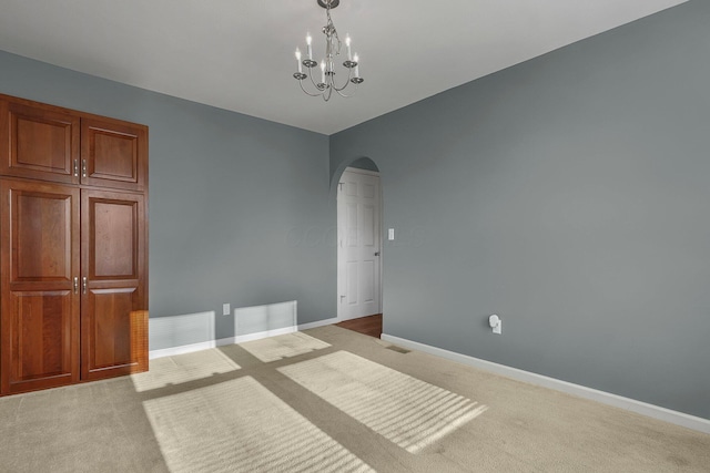 interior space with light carpet and an inviting chandelier