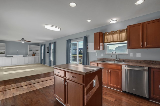 kitchen with dark hardwood / wood-style flooring, sink, a kitchen island, and stainless steel dishwasher