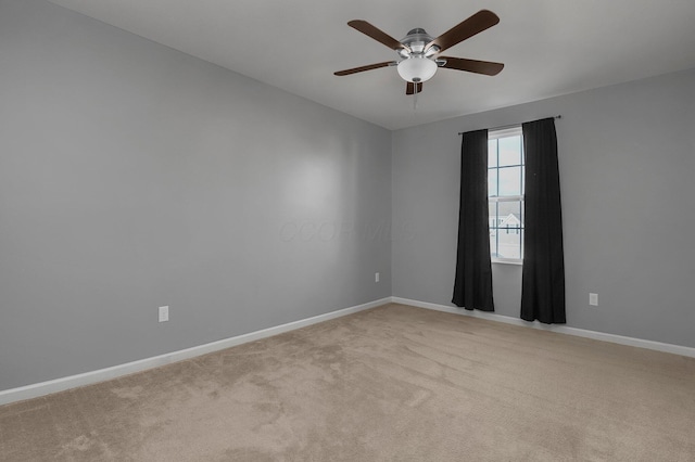 carpeted empty room featuring ceiling fan