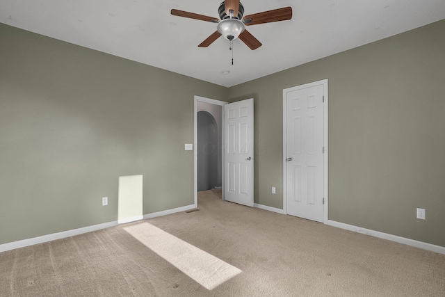 unfurnished bedroom with ceiling fan and light carpet