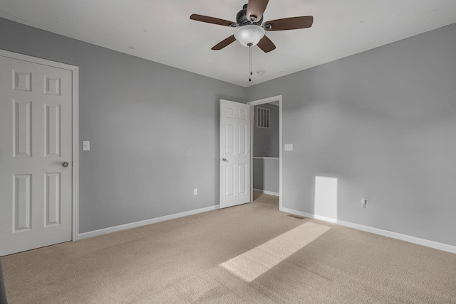 empty room featuring light carpet and ceiling fan