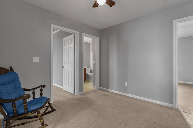 sitting room featuring light carpet and ceiling fan