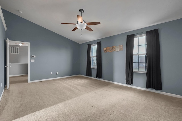 unfurnished room with ceiling fan, carpet, and vaulted ceiling