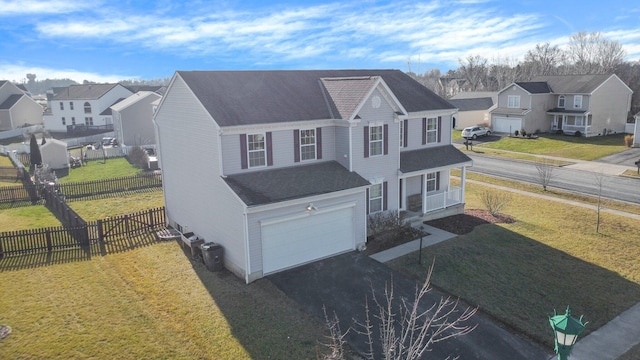 view of front of home with a garage and a front lawn