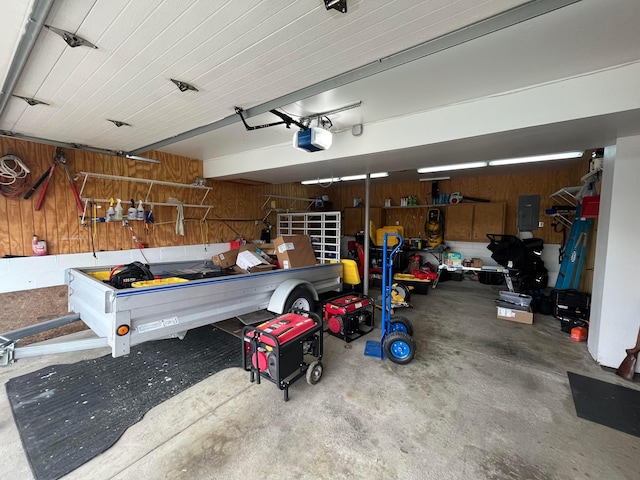 garage with electric panel, a garage door opener, and wooden walls